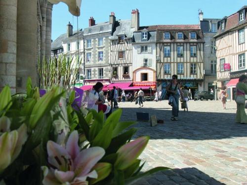 a group of people walking around a city with buildings at Luxury Villa in France with Pool and Garden in Vasles