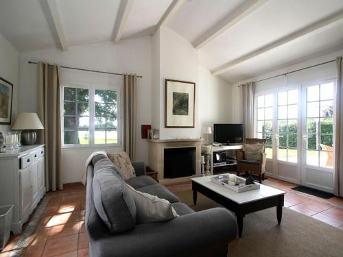a living room with a couch and a table at Villa with garden near beautiful golf course in Vasles