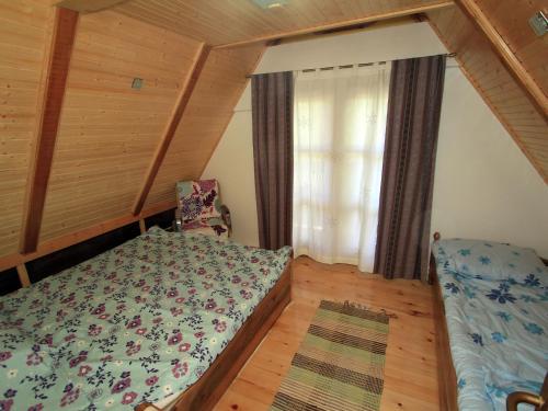 a small bedroom with a bed and a window at Holiday Home in Brod na Kupi by River Kupa in Brod na Kupi
