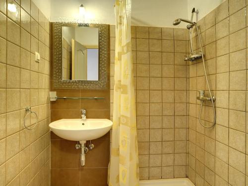 a bathroom with a sink and a shower with a mirror at Villa in Batlug with Private Pool in Batlug