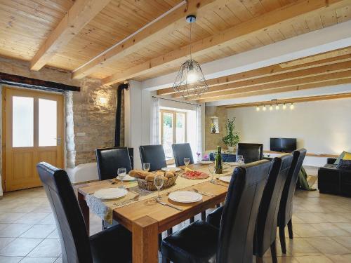 a dining room with a large wooden table and chairs at Villa in Batlug with Private Pool in Batlug