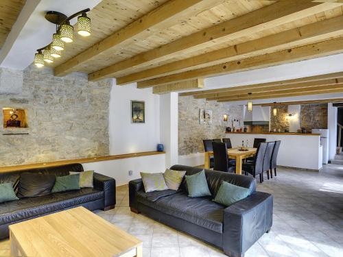 a living room with leather couches and a table at Villa in Batlug with Private Pool in Batlug