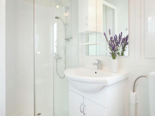 a white bathroom with a sink and a shower at Modern chalet with 2 bathrooms in Vrsar