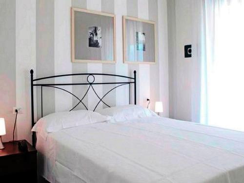 a bedroom with a large white bed with two pillows at Modern furnished apartment with air conditioning in Chianti in Tavarnelle Val di Pesa