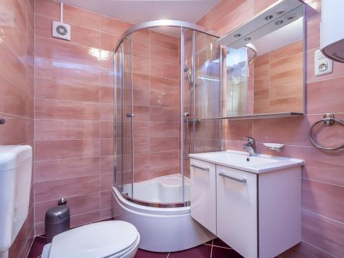 a bathroom with a toilet and a sink and a shower at Apartment in Medulin near Sandy Beaches in Medulin