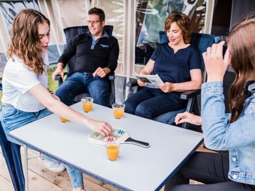 a group of people sitting around a table at Tent Lodge in Larochette near Forests & Castles in Medernach