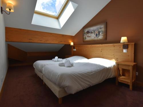 a bedroom with two beds and a skylight at Modern apartment near the ski lift in an authentic village in Sainte-Foy-Tarentaise