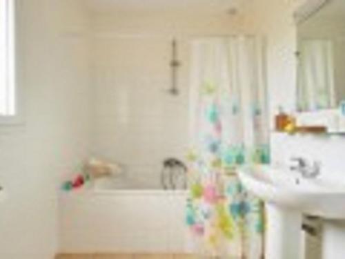 y baño con bañera, lavamanos y bañera. en Modern villa with private pool in the beautiful Loire, en Les Forges
