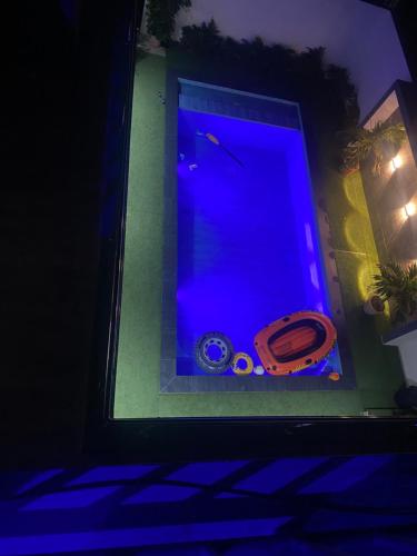 a swimming pool with blue lights in a house at Villa Asya in Somone