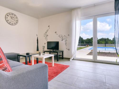 a living room with a couch and a clock on the wall at Villa in Barban near Beach & Pool in Rebići
