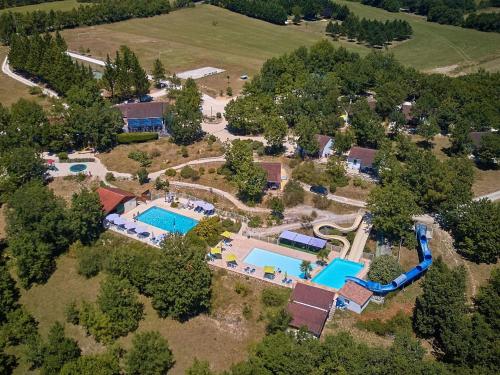 an aerial view of an estate with a swimming pool at Bungalow with a terrace on a hill in Dordogne in Mauroux