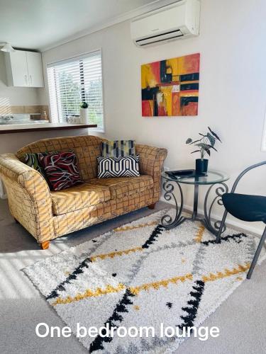 a living room with a couch and a table at Habour View - Tauranga Central in Tauranga