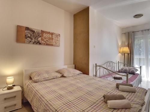 ein Schlafzimmer mit einem Bett mit zwei Kissen darauf in der Unterkunft Quaint Holiday Home in Li njan with Pool and Covered Deck in Ližnjan