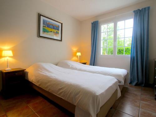 two beds in a room with a window at Luxury Villa in France with Pool in Vasles