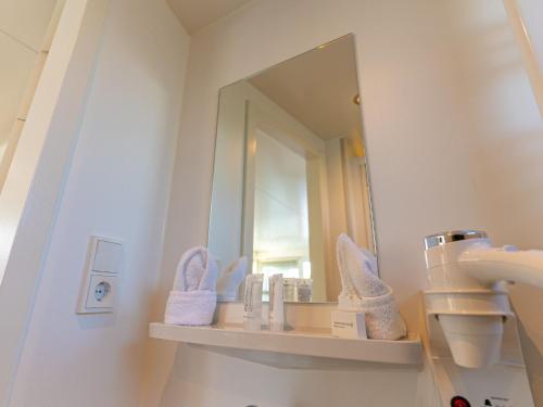 a bathroom with a sink and a mirror at Lush houseboat with roof terrace in Lemmer in Lemmer