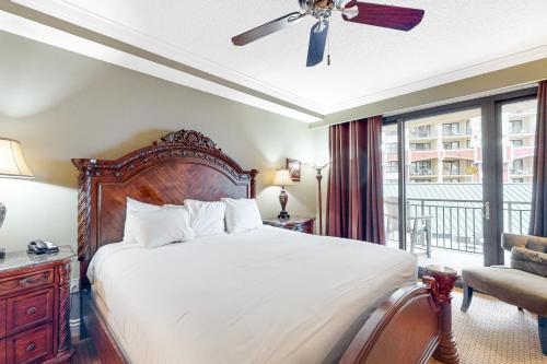 a bedroom with a large bed and a balcony at Emerald Grande W621 in Destin