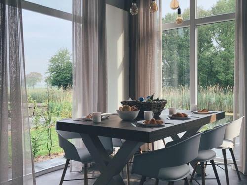 Nice chalet on the water with wood-fired hot tub, in a holiday park