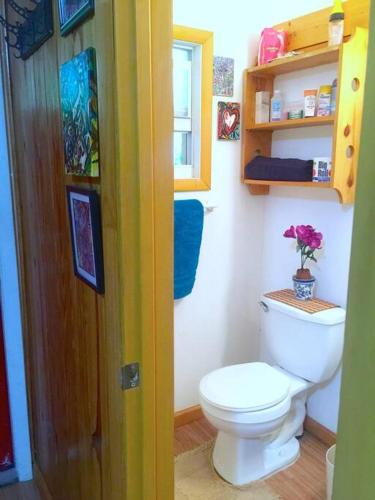a small bathroom with a toilet and a window at Miami Bungalow Oasis near Everglades & The Keys in Cutler Bay