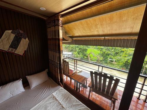 a bedroom with a bed and a large window at VuLinh Family -Homestay in Yên Bình