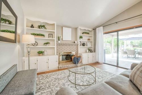 a living room with a couch and a fireplace at Stylish 3BR/2BA Retreat w/ Pool! Dream Getaway in Fresno