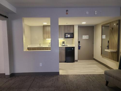 a room with a kitchen with a sink and a refrigerator at Holiday Inn Express Fort Lauderdale North - Executive Airport, an IHG Hotel in Fort Lauderdale