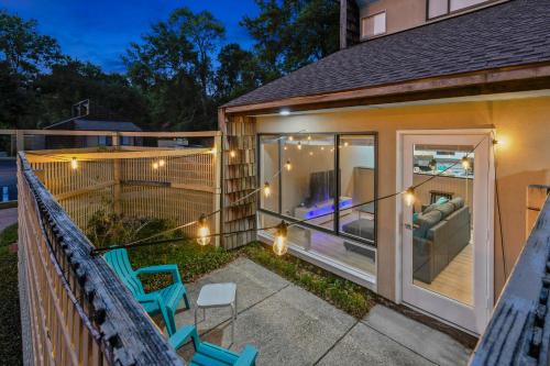 a screened in porch of a house with chairs and a patio at NEW King with Loft Beach Near Gulf in Gulfport