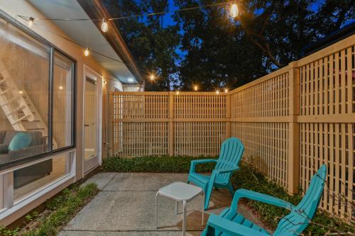 a patio with two chairs and a fence at NEW King with Loft Beach Near Gulf in Gulfport