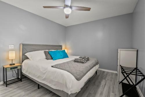 a bedroom with a bed with a ceiling fan at NEW King with Loft Beach Near Gulf in Gulfport