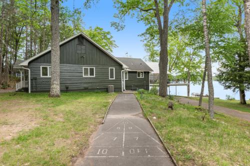 a black house with a path in front of it at Northwoods Oasis in Land O' Lakes