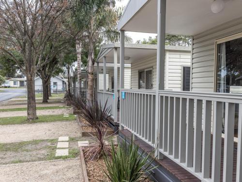 a front porch of a house with white railing at NRMA Phillip Island Beachfront Holiday Park in Cowes