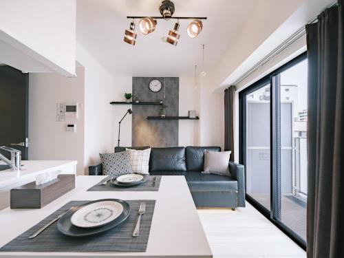 a living room with a couch and a table at Ustay ueno in Tokyo
