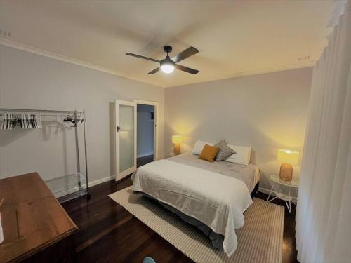 a bedroom with a bed and a ceiling fan at Dempster House in Esperance