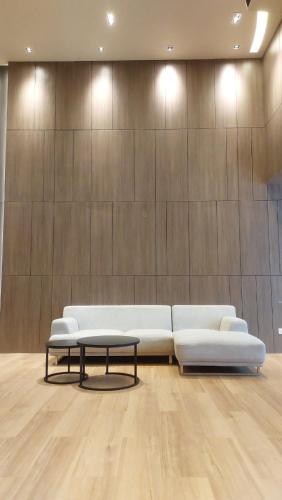 a living room with a white couch and a coffee table at Hotel Grand Galaxy in Yangon