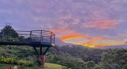 a viewing platform with a rainbow in the sky at Hotel Finca 360 in Marsella
