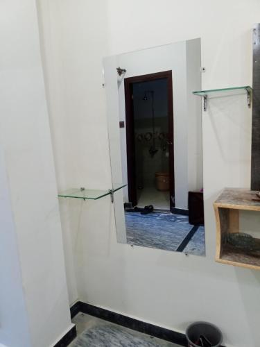 a mirror on a wall in a room at Hotel Red Roof & Restaurant in Abbottābād