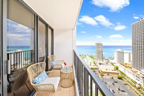 a balcony with chairs and a view of the ocean at Gorgeous Condo with Ocean View, Near Beach, Free Parking in Honolulu