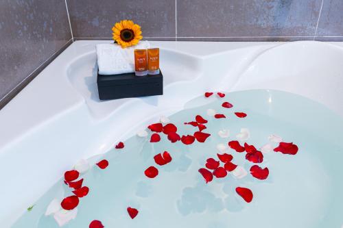 a bathroom with a tub with red flowers on it at Navy Hotel Nha Trang in Nha Trang