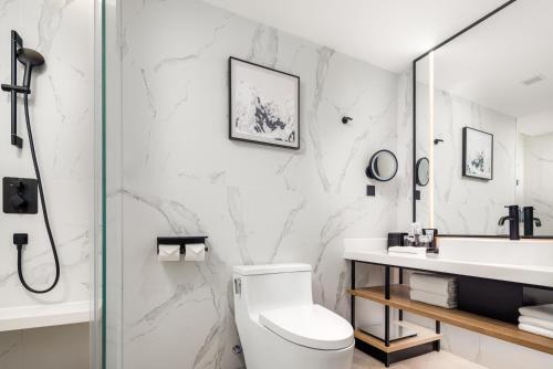 a bathroom with a toilet and a sink and a shower at Sheraton Chengdu Lido Hotel in Chengdu