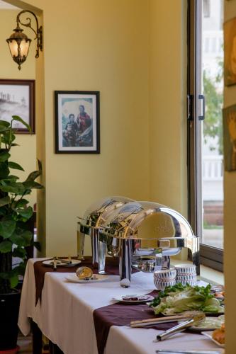 a table with a plate of food on it at Ladybird Boutique Hotel in Sa Pa
