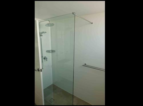 a glass shower stall with a glass door at Oceanic 19 - linen not included in Forster