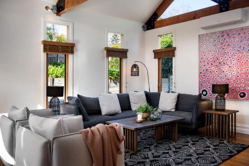 a living room with a couch and a table at Ravenswood- elegance and old world charm in Daylesford