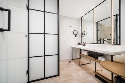 a bathroom with a sink and a mirror at Sheraton Chengdu Lido Hotel in Chengdu