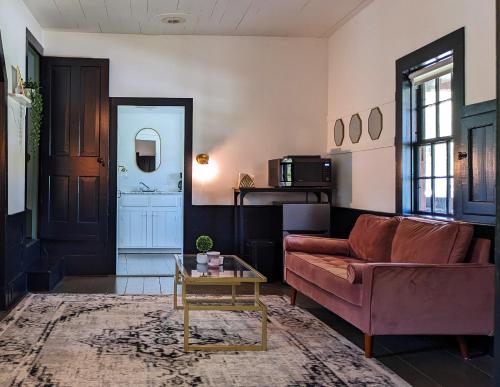 a living room with a couch and a table at Whimsical Cottage w/ Pond View in Dundee