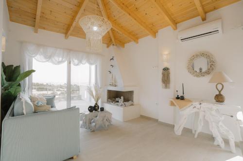 a living room with white walls and a wooden ceiling at MIRAMAR KARYSTOS in Karistos