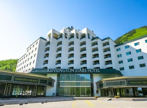 a white hotel with a sign on the front of it at KensingtonHotel Seorak in Sokcho