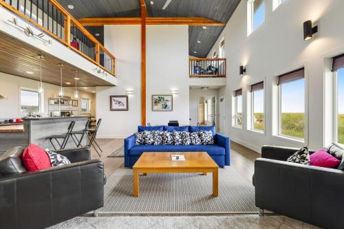 a living room with two blue couches and a table at Blue Ocean Lodge in Westport