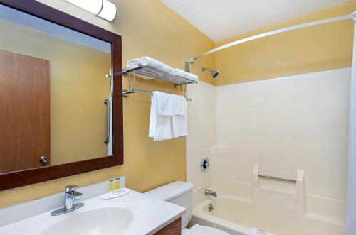a bathroom with a sink and a toilet and a mirror at Super 8 by Wyndham Somerset in Somerset