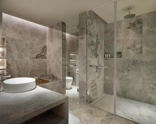 a bathroom with a shower and a tub and a sink at Le Meridien Hangzhou, Binjiang in Hangzhou