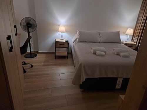a bedroom with a bed with two towels on it at Venue Studios in Lima