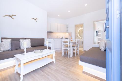 a living room with a couch and a table at RODAVGI APARTMENTS in Andros